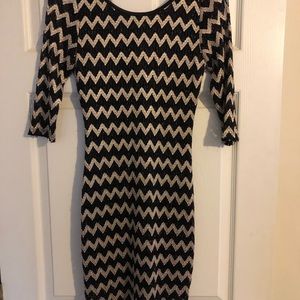 Black and gold short fitted dress with low back.